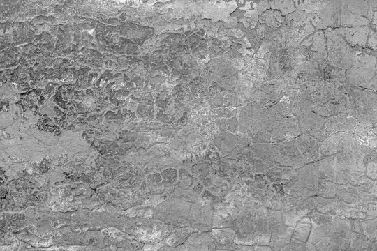 Destroyed crumbled plaster on aged vintage brushed surface. Shabby antique urban street grunge. Rough peeling chipped traces on worn block. Old rustic stone fence. Retro bumpy grit slab for 3d design