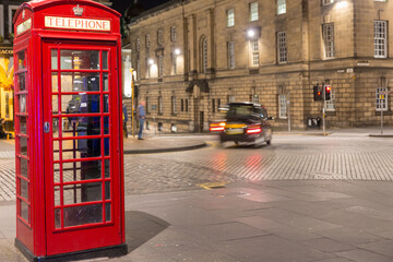 Classic red British telephone box, night scene