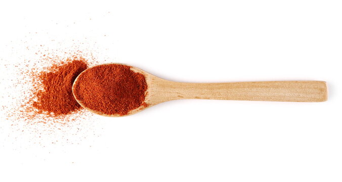 Spicy red milled ancho chili pepper powder isolated on white background, top view