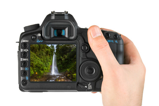 Hand with camera and Gitgit Waterfall in Bali Indonesia (my photo)