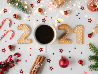 Gingerbread cookies in the form of numbers of 2021 and coffee. New year background