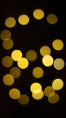 Abstract evening night shimmering bokeh background effect street outside near cafe restaurant. Defocused urban city life blur golden light bulbs garlands. Christmas New Year party holiday concept. 