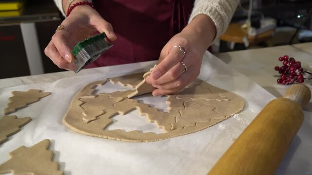 Vegan chef girl cooking sweets wearing santa hat with christmas decoration in christmas kitchen