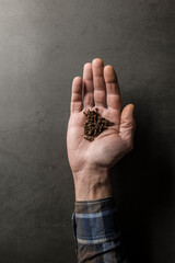 man's hand with cloves on grey stone background