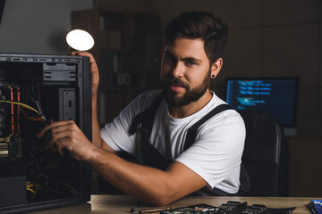 Technician repairing computer in service center