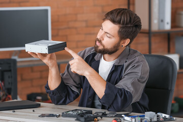 Technician repairing computer in service center