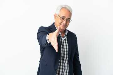 Middle age Brazilian man isolated on white background shaking hands for closing a good deal