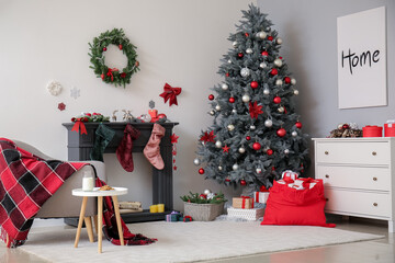 Interior of living room with Santa bag, fireplace and beautiful Christmas tree
