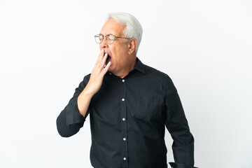 Middle age Brazilian man isolated on white background yawning and covering wide open mouth with hand