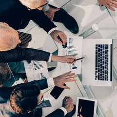 business colleagues using a laptop to work with financial statistics.