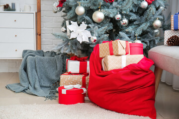 Santa bag with Christmas gifts in room