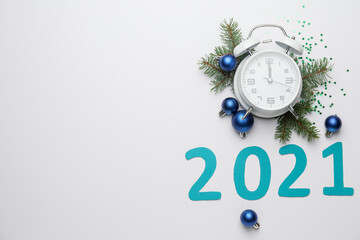 Fototapeta premium New Year composition with alarm clock and figure 2021 on light background