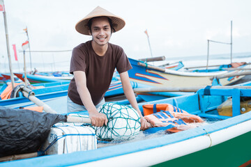 Portrait of a young male fisherman ready go to fishing