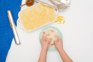 step-by-step recipe for the holiday of Hanukkah, a traditional Kugel pie with noodles and custard, sand crumbs on top. the ingredients in the dishes on a light background, top view