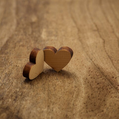 Fototapeta premium wooden hearts placed nicely on wood background