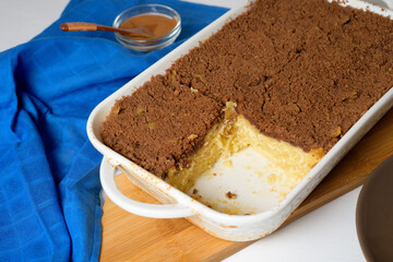 step-by-step recipe for the holiday of Hanukkah, a traditional sweet Kugel pie with noodles and custard, shortbread cocoa crumbs on top. on a light background in a baking dish