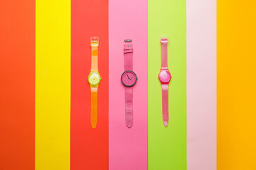 Wrist watches on colorful background