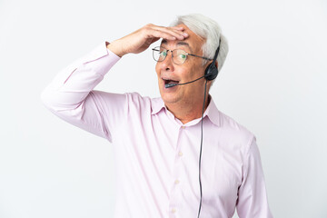 Telemarketer Middle age man working with a headset isolated on white background doing surprise gesture while looking to the side