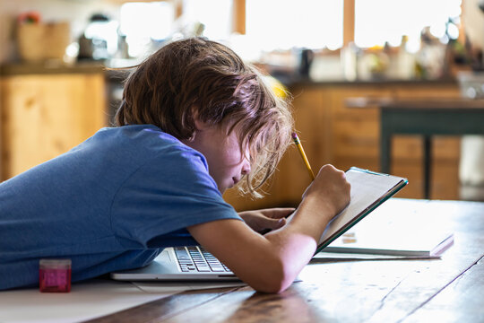 Young boy tracing on his laptop computer