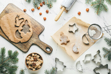 Composition with fresh dough for gingerbread cookies and cutters on white background