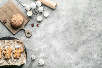 Tasty gingerbread cookies with ingredients on grunge background