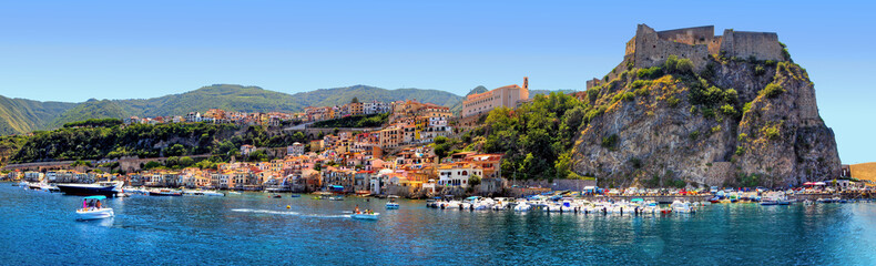 Fototapeta na wymiar The southern coast of Scilla, Calabria, Italy, in midsummer, overlooking the bathing establishments and the old Ruffo Castle