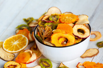 Organic Healthy Assorted Dried Fruit Mix close up. Dried fruit snacks. dried apples, mango, feijoa, dried apricots, prunes top view