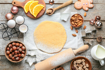Fresh dough for gingerbread cookies and ingredients on table