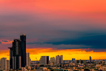 Fototapeta premium The high angle background of the city view with the secret light of the evening, blurring of night lights, showing the distribution of condominiums, dense homes in the capital community