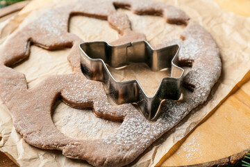 Fresh dough for gingerbread cookies and cutter on table