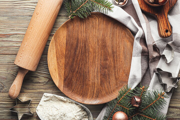 Christmas composition with empty plate, flour and cookie cutters on table