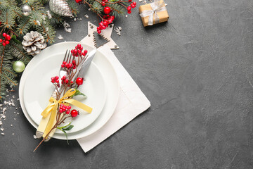 Beautiful Christmas table setting with mistletoe on dark background
