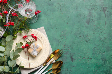 Beautiful Christmas table setting with mistletoe on color background