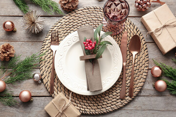Fototapeta na wymiar Beautiful Christmas table setting with mistletoe on wooden background