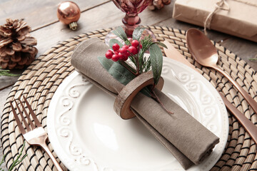 Fototapeta na wymiar Beautiful Christmas table setting with mistletoe on wooden background