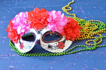 Dia de los muertos mask on a wooden background. Halloween carnival accessories. Day of the dead Masquerade holiday concept