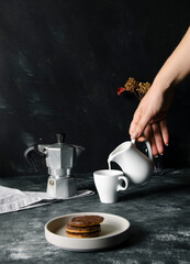 Hot espresso and milk on black table on focus and light in background