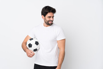 Young handsome man with beard over isolated white background looking side