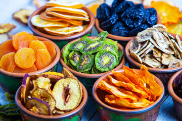 Organic Healthy Assorted Dried Fruit Mix close up. Dried fruit snacks. dried apples, mango, feijoa, dried apricots, prunes top view