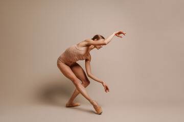 Sensual young woman ballet dancer performing