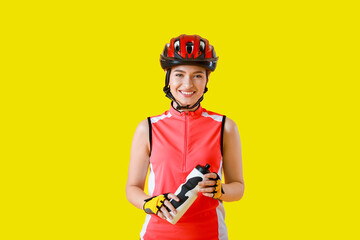 Female cyclist with bottle of water on color background