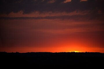 Fototapeta premium Hot sunset above the forest. bright colors at the end of a summer day