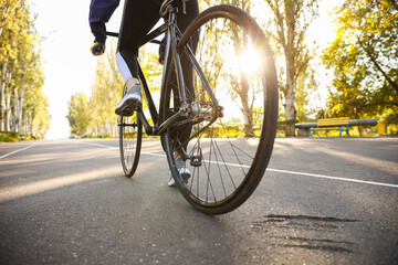 Fototapeta na wymiar Female cyclist riding bicycle outdoors