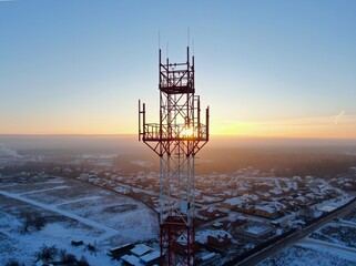 Aerial view panoramic landscape of cell towers at dawn in winter. Telecommunications and Communications Industry Infrastructure