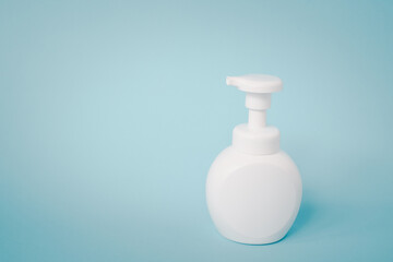 white pump bottle on grunge blue background