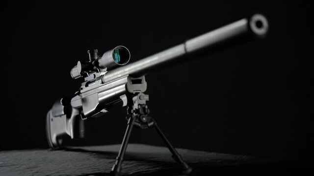 focus and movement from the top of the silencer to the butt of Sniper rifle Sako TRG 41 on black background