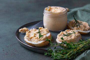 Sandwiches with smoked salmon and soft cream cheese pate or mousse with thyme and rosemary on a...
