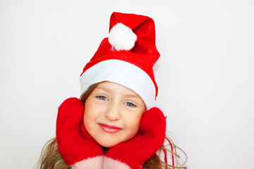 Beautiful girl red sweater Christmas and New year gift. Happy small girl in Santa s hat has a Christmas.