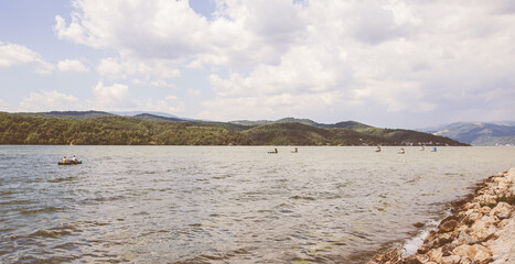 Adventure on the water, exploring, kayaking on the river, group of kayakers on Danube river. Beautiful summer nature landscape.