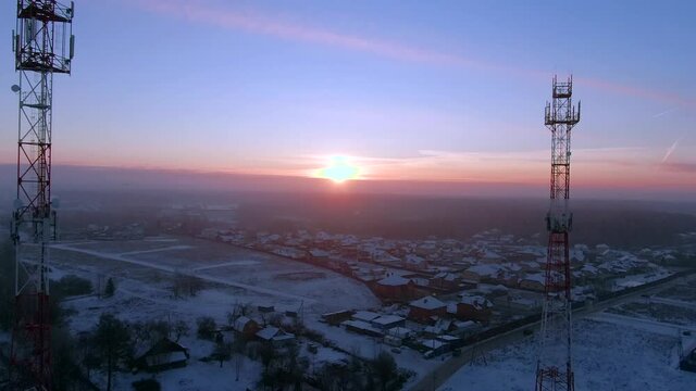 Aerial view panoramic landscape of cell towers at dawn in winter. Telecommunications and Communications Industry Infrastructure